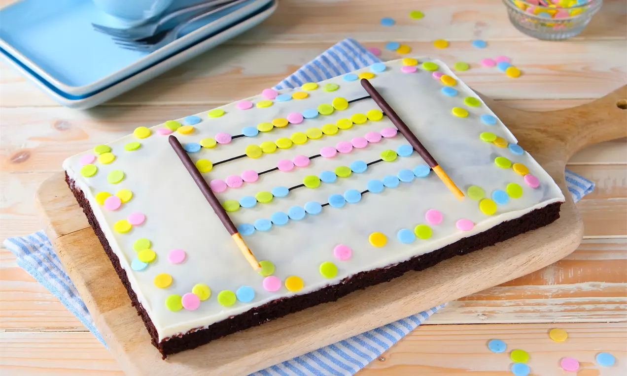 Rechentafel-Kuchen als Brownie mit weißer Glasur und bunter Zuckerschrift – kreatives Kuchenrezept zur Einschulung, einfach gebacken und individuell verziert.